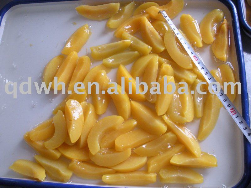 Yellow peach slices in tins