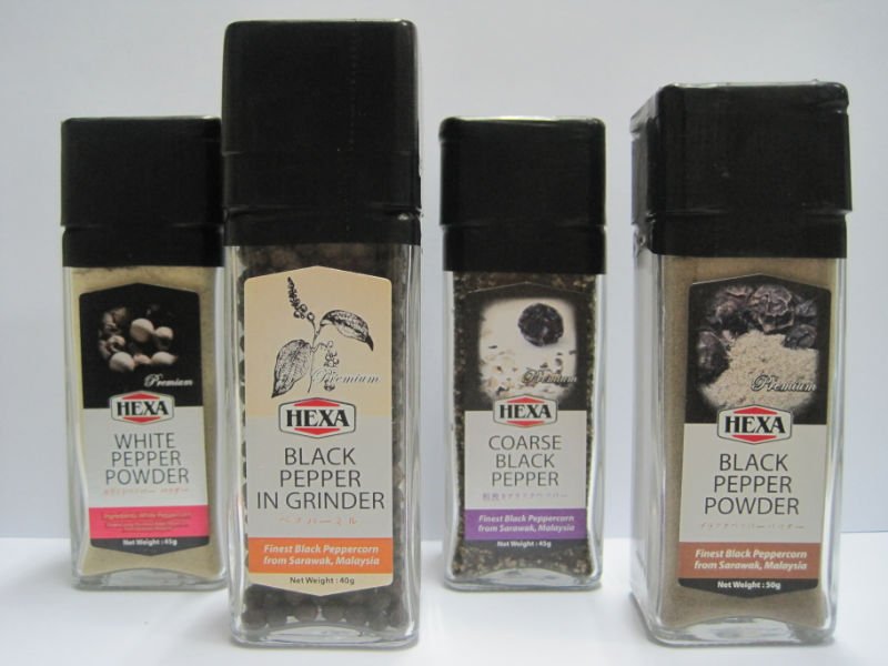 Black and  White  Pepper in glass  jar  with grinder