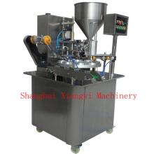 Rotary filling and sealing machine