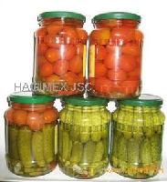 Assorted cherry tomato and baby cucumber in jars